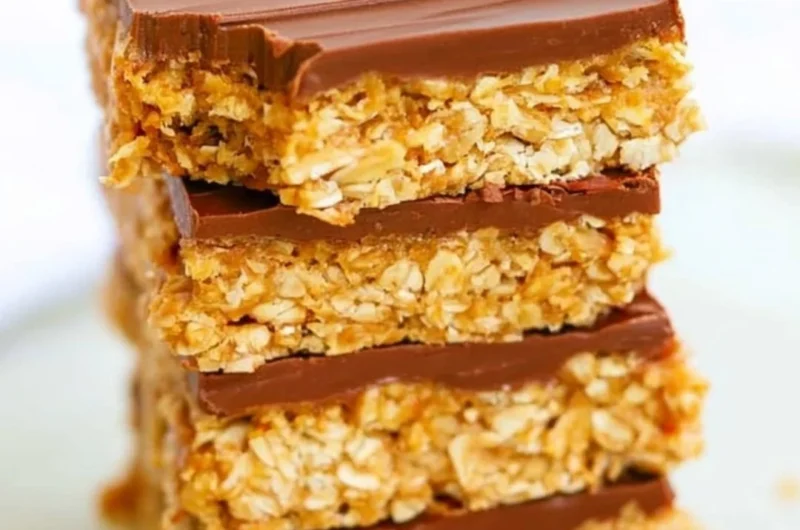 Healthy chocolate peanut butter oatmeal bars on a wooden table.