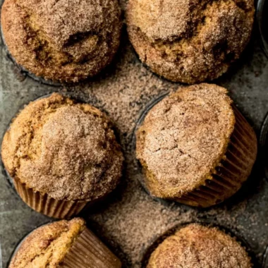 Freshly baked Pumpkin Snickerdoodle Muffins topped with cinnamon sugar