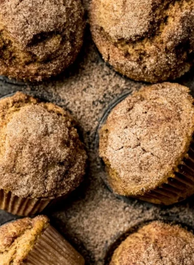 Freshly baked Pumpkin Snickerdoodle Muffins topped with cinnamon sugar