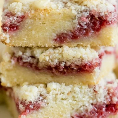 Delicious raspberry almond crumb bars with a golden crumb topping